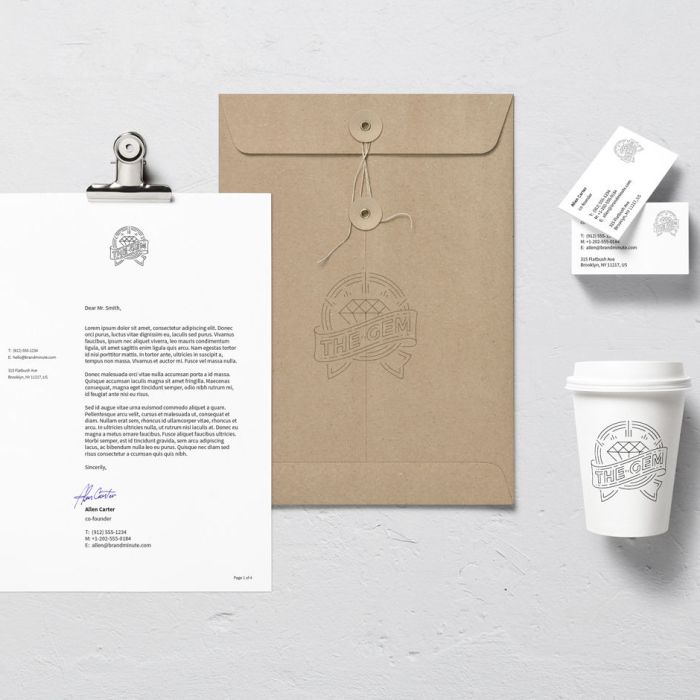 A mockup of branded stationery on a white surface, including a letter on a clipboard, a brown envelope, business cards, and a white coffee cup, all featuring the same black outlined logo.