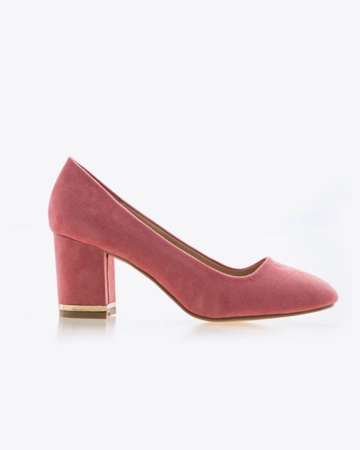 A pink suede high-heeled shoe with a closed toe and a thick block heel, shown in profile on a white background.