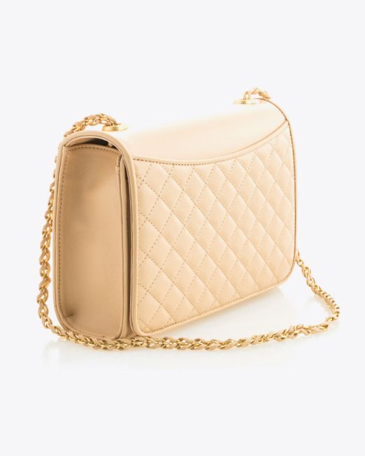 A beige quilted leather handbag with a gold chain strap, displayed at an angle on a white background. The bag has a flap closure and diamond stitching pattern.