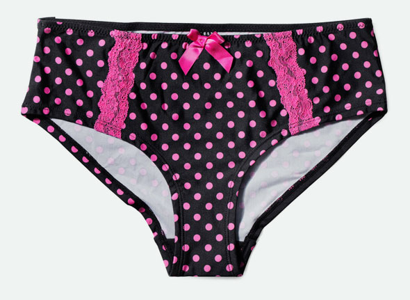 Black womens underwear with pink polka dots, pink lace side panels, and a small pink bow at the center of the waistband, displayed on a plain background.
