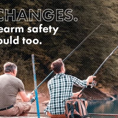 Two people sit on a dock fishing beside a lake with text saying, “Life changes. Your firearm safety plan should too,”.